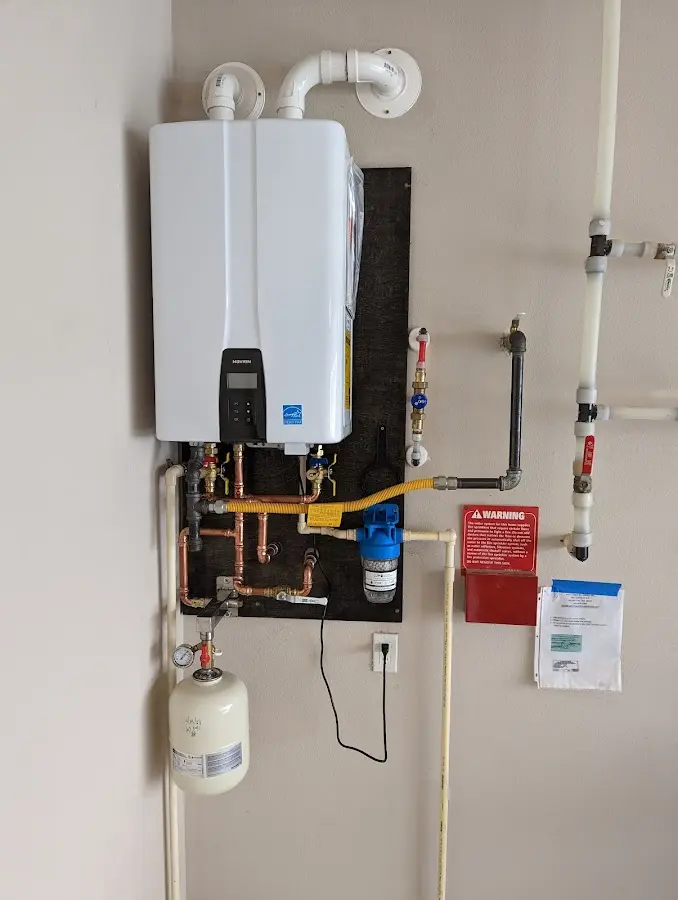 Professional plumber installing copper piping in a Northborough home